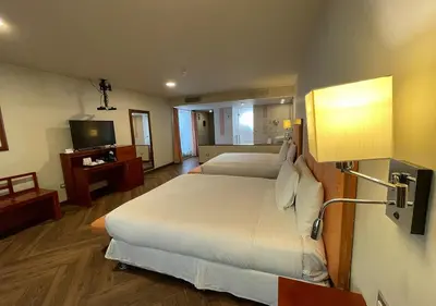 a hotel room with two beds and a television at Aranwa Sacred Valley Hotel & Wellness in Urubamba