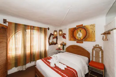 a bedroom with a bed with a white animal on it at Hostal Madre Tierra in Cusco