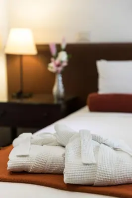 a bed with two white towels on top of it at LP Los Portales Hotel Cusco in Cusco
