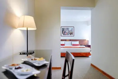 a room with a bed and a table with food on it at LP Los Portales Hotel Cusco in Cusco