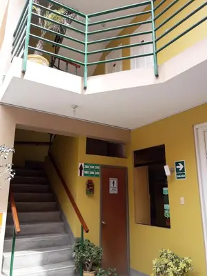 a staircase in a building with a balcony at Hostal Tambo Colorado in Pisco