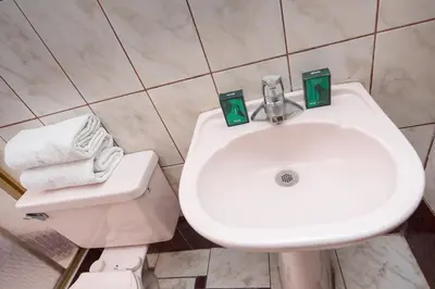 a bathroom with a white sink and a toilet at Ayenda Casa Escondida San Cristóbal Premium in Cusco