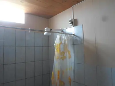 a shower with a shower curtain in a bathroom at La Casa Maruja in Lima