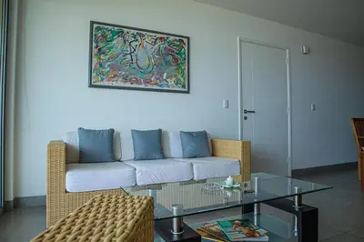a living room with a couch and a glass table at Condominio Nuevo Paracas in Paracas