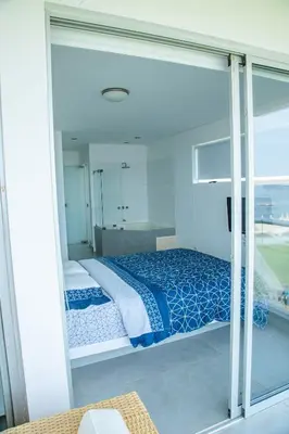 a bedroom with a bed and a large window at Condominio Nuevo Paracas in Paracas