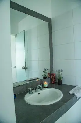 a bathroom with a sink and a mirror at Condominio Nuevo Paracas in Paracas
