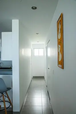 a hallway with white walls and a white door at Condominio Nuevo Paracas in Paracas