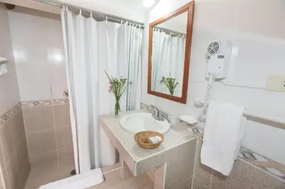 a bathroom with a sink and a shower at SAUCE Hotel Boutique in Ollantaytambo