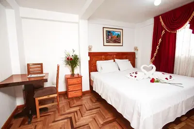a hotel room with a bed and a desk at Hostal Danna Inn in Cusco