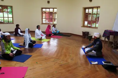 a group of people sitting on the floor in a yoga class at Hotel Villa Urubamba in Urubamba