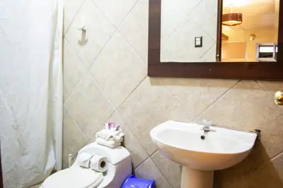 a bathroom with a sink and a toilet and a mirror at Hotel Royal Qosqo in Cusco
