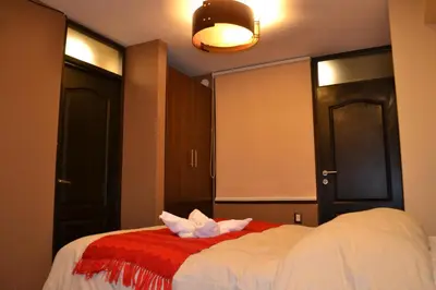 a bedroom with a bed with two towels on it at Hotel Royal Qosqo in Cusco