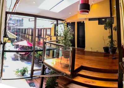 a balcony of a building with stairs and plants at Hotel Royal Qosqo in Cusco