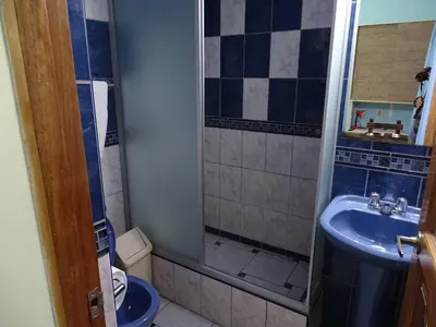 a bathroom with a shower and a sink at Ccapac Inka Ollanta Casa Museo in Ollantaytambo