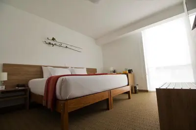 a bedroom with a large bed with white sheets at Tierra Viva Miraflores Mendiburu in Lima