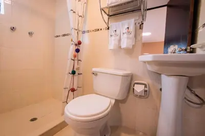 a bathroom with a toilet and a sink at Mayu Boutique Hotel in Cusco