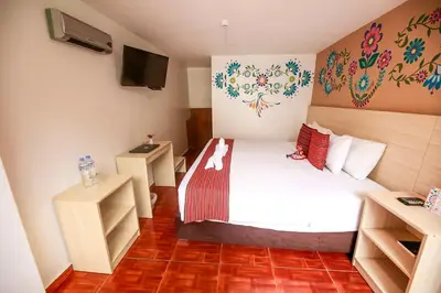 a hotel room with a bed and a tv at Mayu Boutique Hotel in Cusco