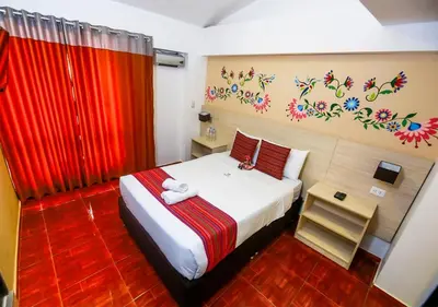 a bedroom with a bed with a red curtain at Mayu Boutique Hotel in Cusco