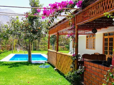 a house with a yard with a swimming pool at Casa de Campo Chinkay - Lunahuana in Lunahuaná