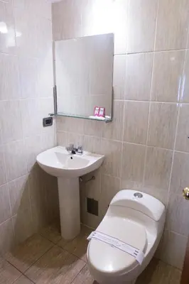 a bathroom with a toilet and a sink at Antawasi Hotel in Cusco