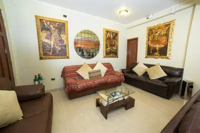 a living room with a couch and a coffee table at Antawasi Hotel in Cusco