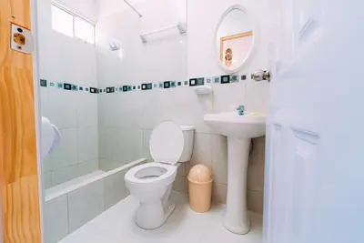 a bathroom with a toilet and a sink at Hospedaje Mary in Paracas