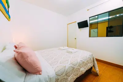 a bedroom with a bed with a pillow on it at Hospedaje Mary in Paracas