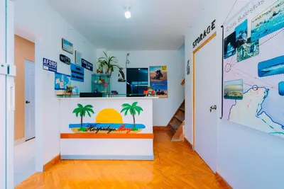 a hallway with a room with palm trees on the wall at Hospedaje Mary in Paracas