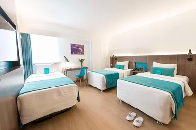 a hotel room with two beds and a desk at Libre Hotel, BW Signature Collection by Best Western in Lima