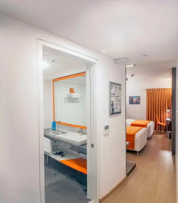 a bedroom with a bed and a sink and a mirror at Libre Hotel, BW Signature Collection by Best Western in Lima