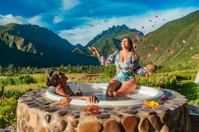 a man and a woman sitting in a hot tub at Inkasaire Boutique Lodge in Urubamba