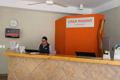a woman sitting at a cash counter in an office at Casa Andina Standard Nasca in Nazca