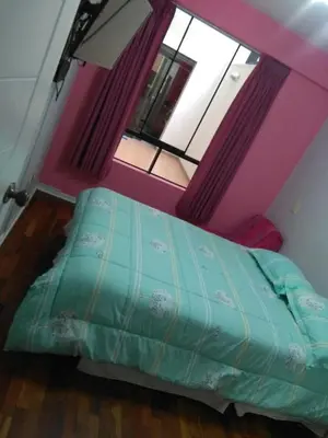 a bedroom with a bed in a room with a window at Mi casa es su casa in Lima