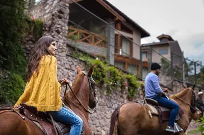 a man and a woman riding on horses at Intiterra Apart Hotel Villas in Urubamba