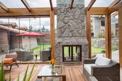 a large living room with a stone fireplace at Intiterra Apart Hotel Villas in Urubamba