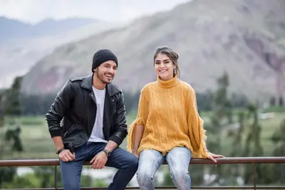 a man and a woman sitting on a rail at Intiterra Apart Hotel Villas in Urubamba