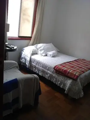 a small bedroom with a bed and a window at Hospedaje Marita in Lima