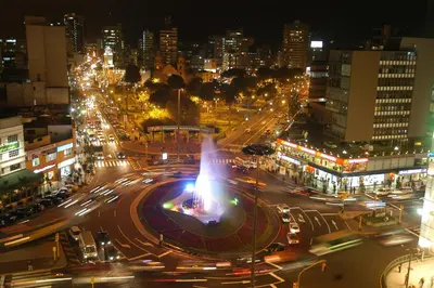 a busy city street at night with traffic at Tambo Dos de Mayo in Lima