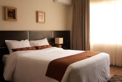 a bedroom with a large bed and a window at Tambo Dos de Mayo in Lima
