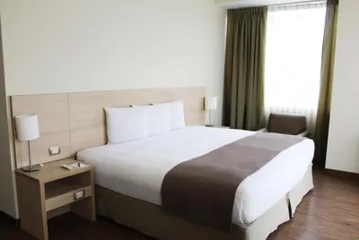 a hotel room with a large bed and a window at Del Prado Hotel in Lima