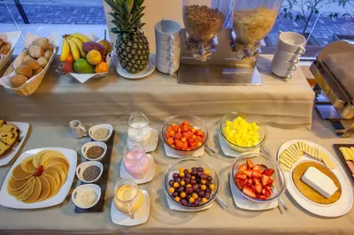 a table with many bowls of different types of food at Del Prado Hotel in Lima