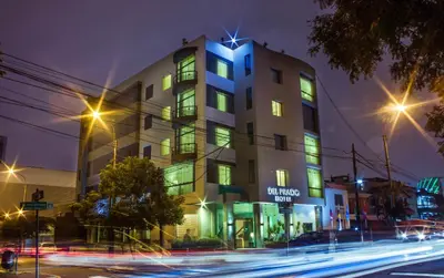 a building with neon lights in front of a street at Del Prado Hotel in Lima