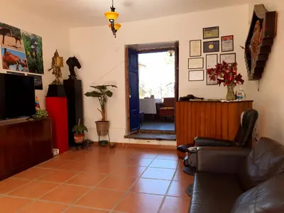 a living room with a couch and a television at Casona Mollepata in Mollepata