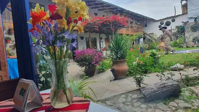 a vase filled with flowers sitting on a table at Casona Mollepata in Mollepata