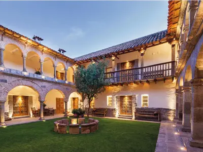 an exterior view of a building with a yard at Inkaterra La Casona Relais & Chateaux in Cusco