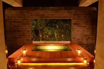 a jacuzzi tub in a room with lights at El MaPi by Inkaterra in Machu Picchu
