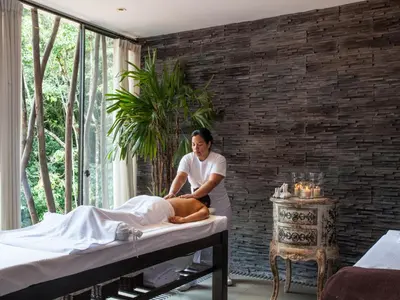 a man waxing a bed in a room at El MaPi by Inkaterra in Machu Picchu