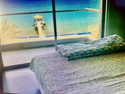 a bedroom with a bed and a view of the ocean at Duplex 1 Fila Vista Bahía Paracas - Sotavento 501 T3 in Paracas