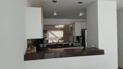 a kitchen with a black counter top in a room at Condominios Nauticos Nuevo Paracas in Paracas