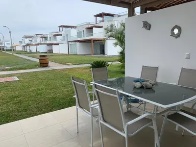 a table and chairs with a teddy bear on it at Condominios Nauticos Nuevo Paracas in Paracas